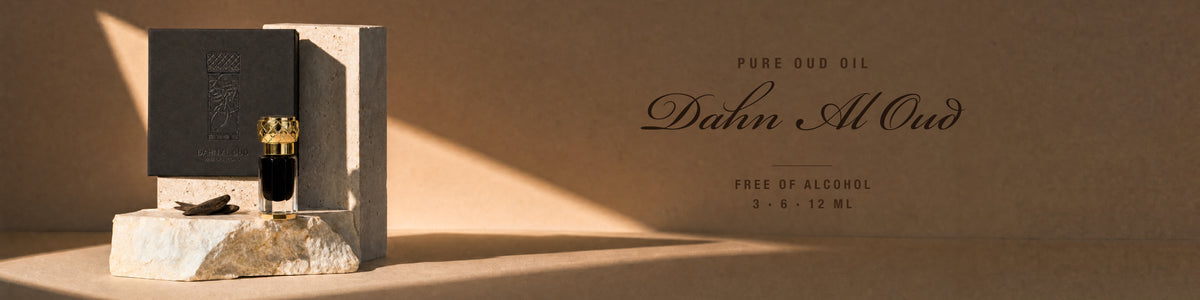 Dahn Al Oud pure oud oil - box and bottle on travertine in sunlight